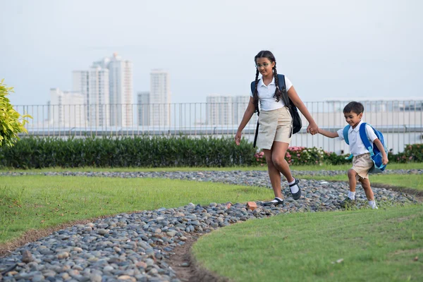 Girl holding hand of her brother — Stock Photo, Image