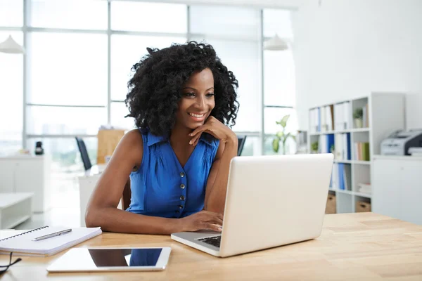 Afro-Amerikaanse vrouw die op laptop werkt — Stockfoto