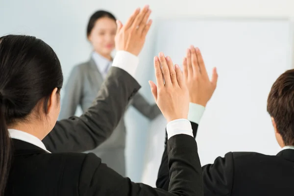 Business people raising hands — Stock Photo, Image