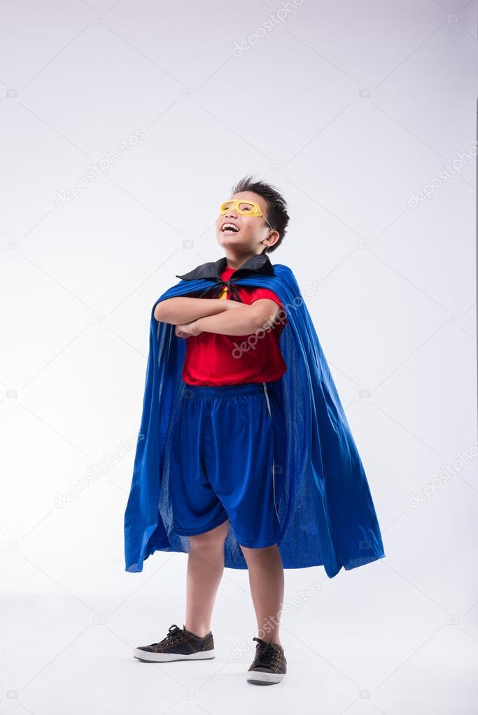 Brave confident boy in superhero costume