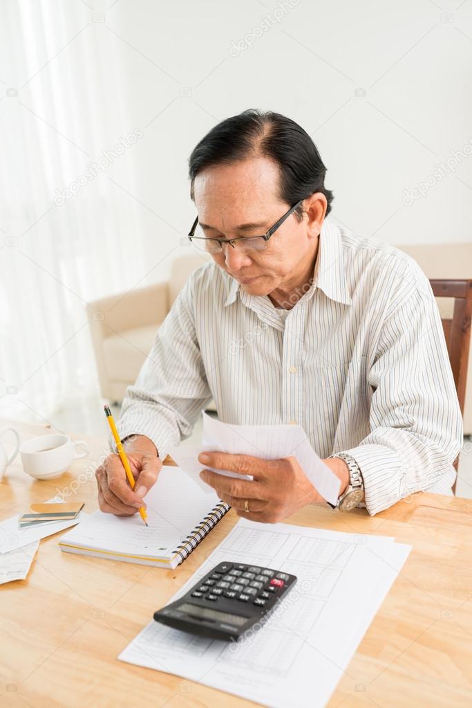 Senior man analyzing family budget