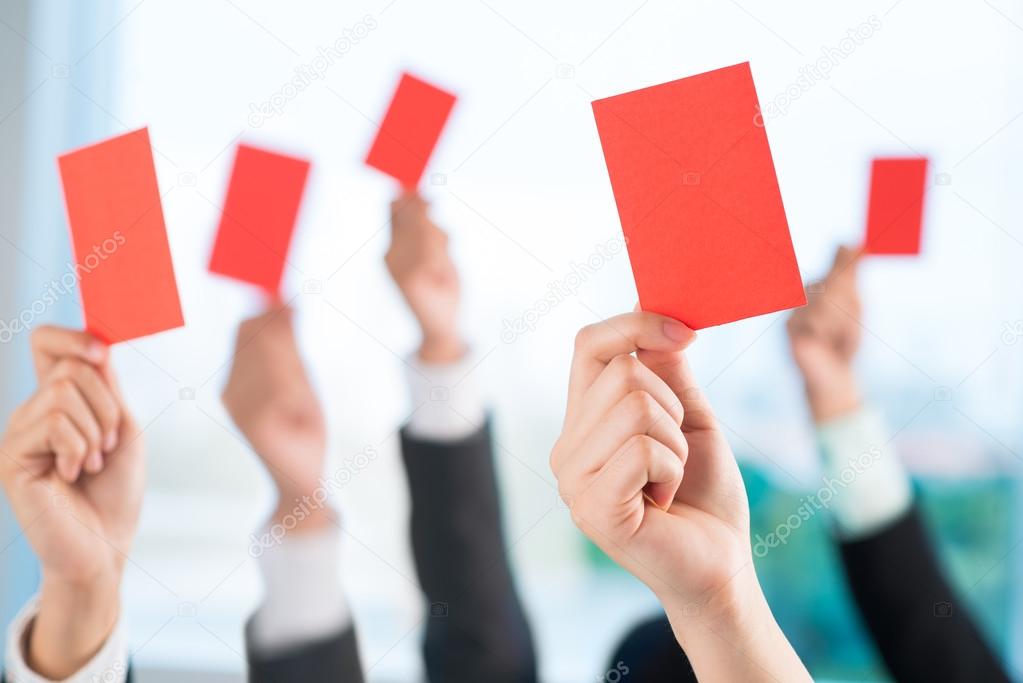 Business people showing red cards