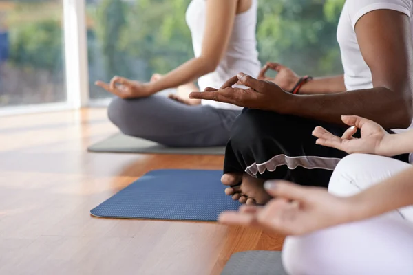 People meditating in lotus position — Stock Photo, Image