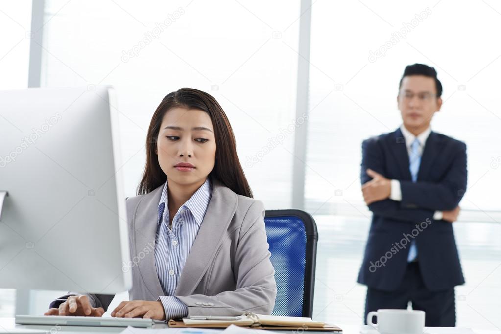 Sad female employee at workplace