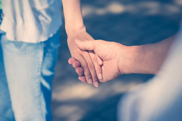 Man holding hand of his adult daughter — Stock Photo, Image