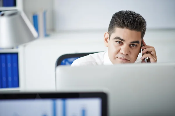 Pensive entrepreneur talking on phone — Stock Photo, Image