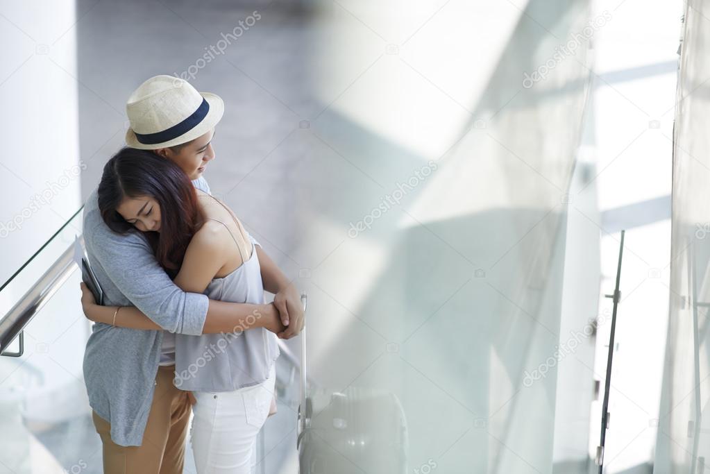 Sad boyfriend and girlfriend hugging