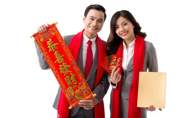 Colleagues with scroll, greeting cards and box — Stock Photo, Image