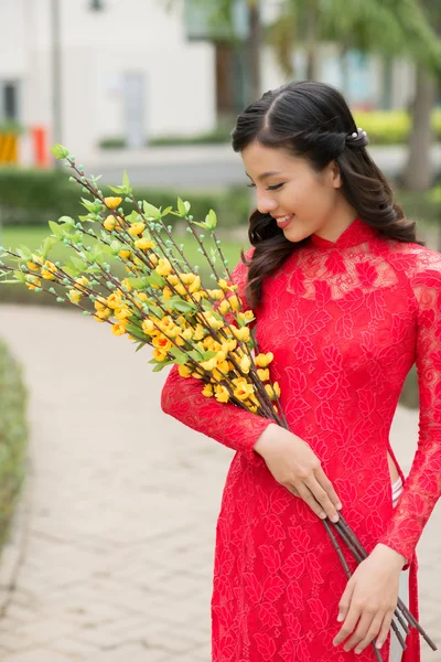 Woman holding blooming branches — Stock Photo, Image