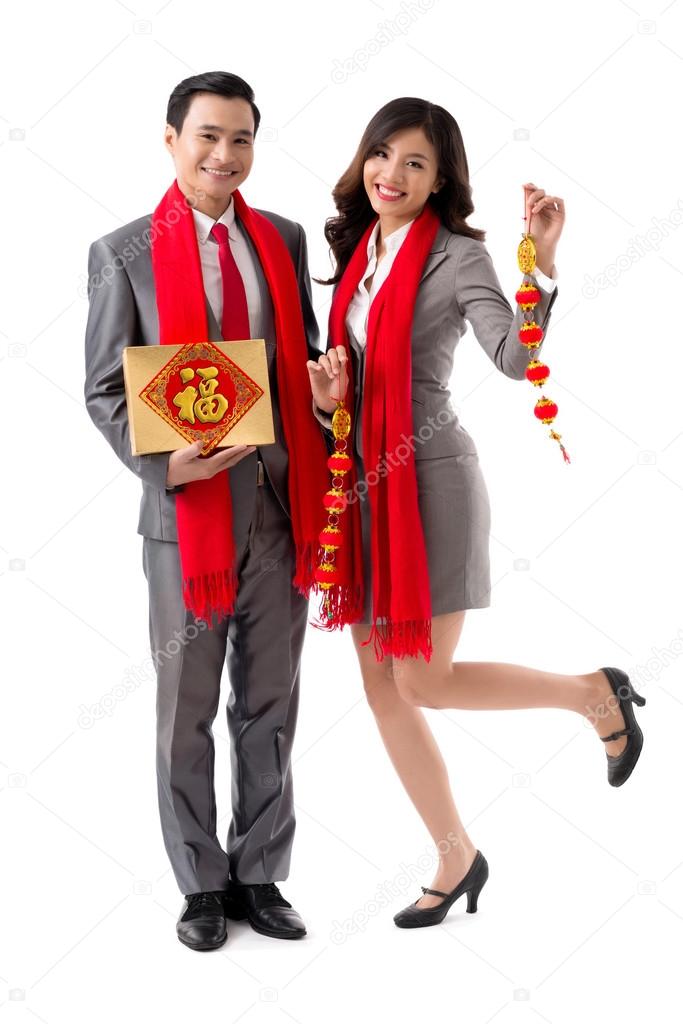 Business couple with box and garland