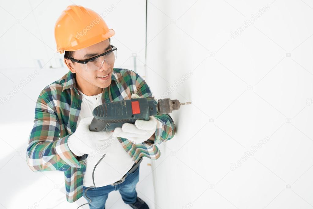 Man making hole in wall