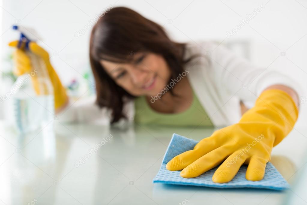 Housekeeper cleaning surface