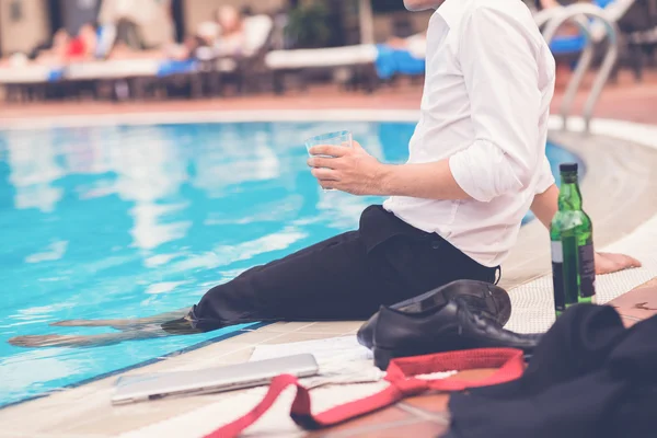Empresário bebendo na piscina — Fotografia de Stock