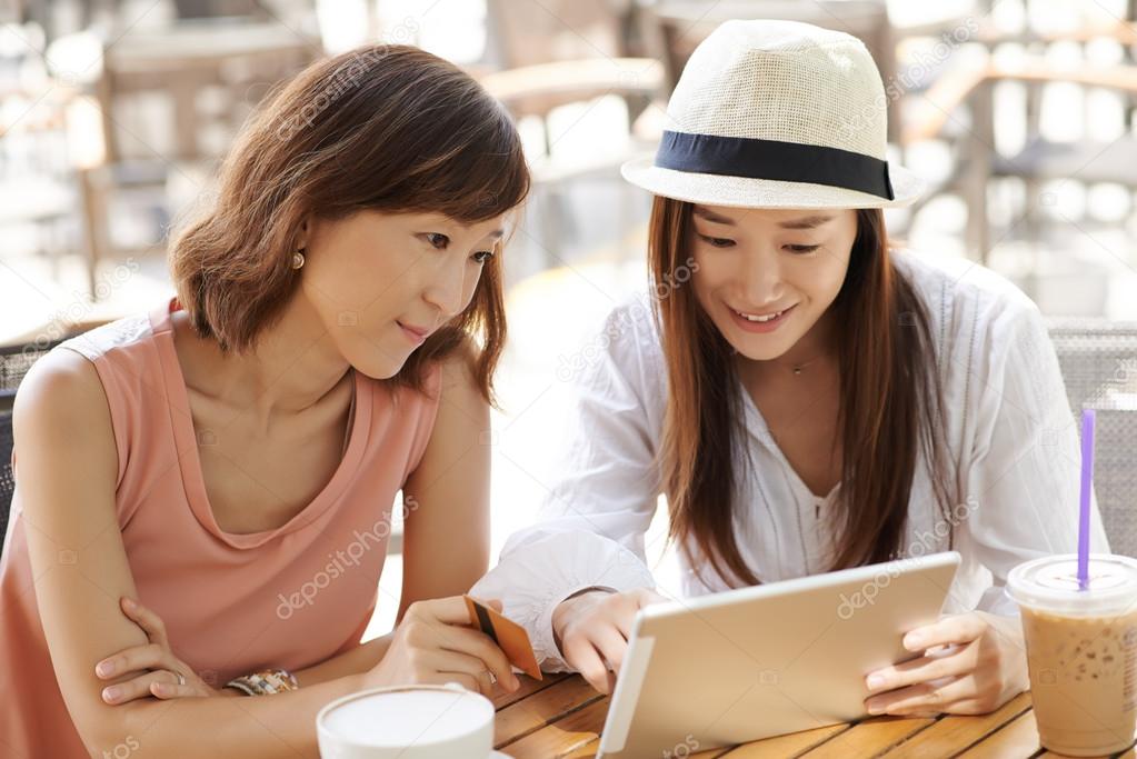 Women using digital tablet