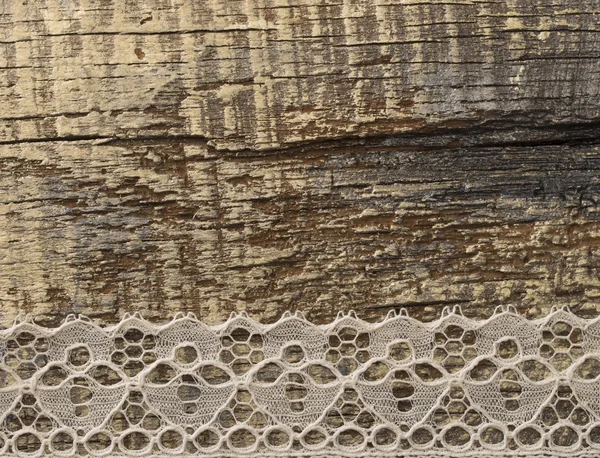 Lace op de houten achtergrond — Stockfoto