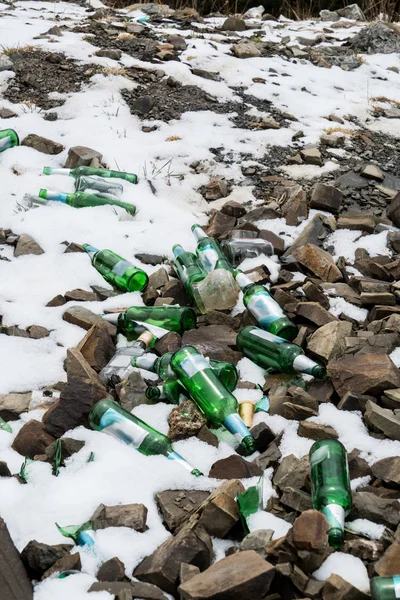 bottle in the mud and snow