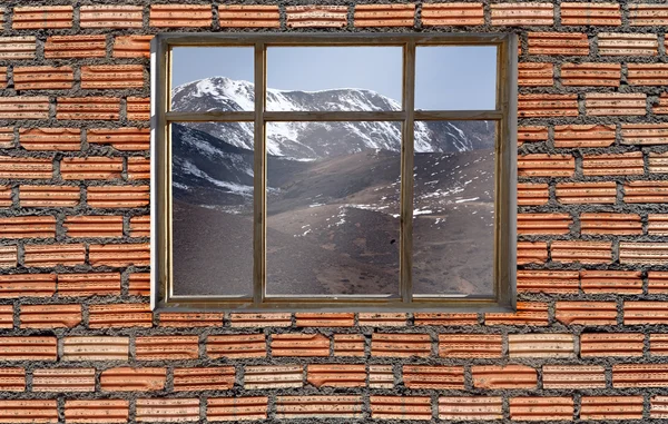 snow mountain outside window with brick wall