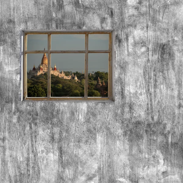 windows frame on cement wall and view of Mandalay, Myanmar