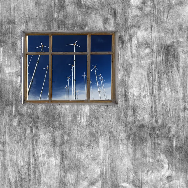 windows frame on cement wall and view of wind turbine