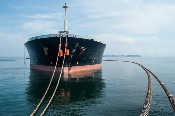 Oil tanker is transferring oil to the cargo vessel