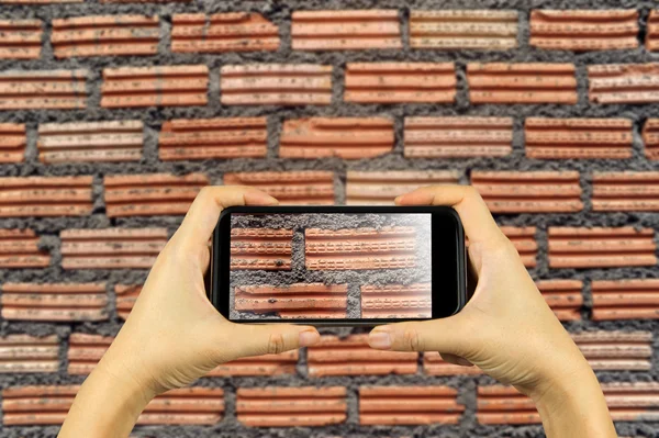 brick wall. Taking photo on smart phone concept.
