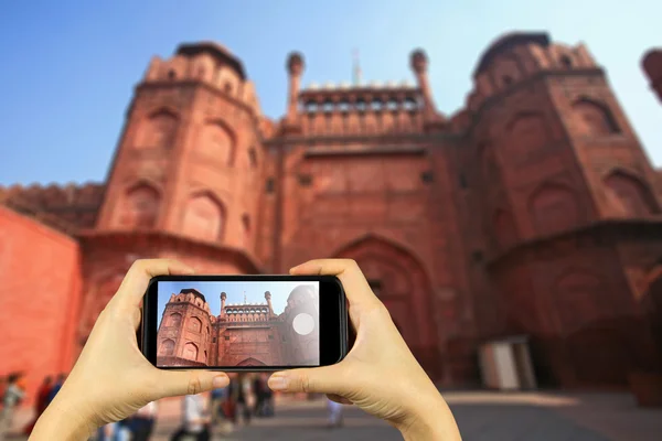 The Red Fort, India. Taking photo on smart phone concept.