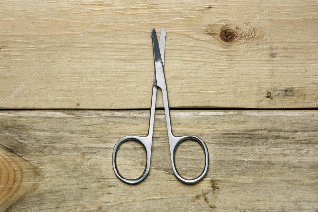 Scissors For Trimming Nose Hair On Wood Background Stock Photo