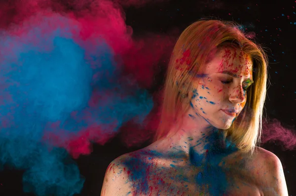 Attractive blond girl in colors paints — Stock Photo, Image