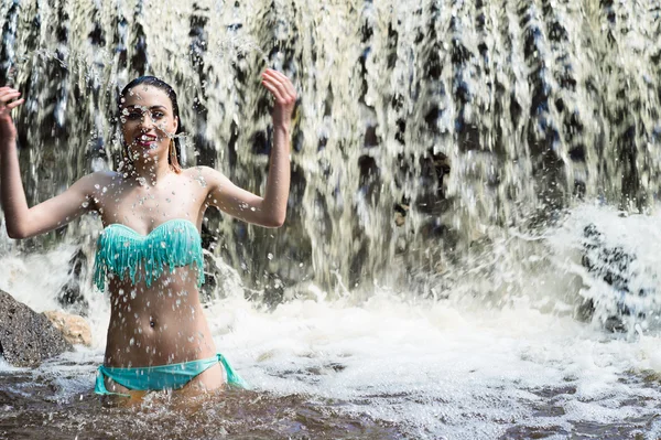 Hermosa mujer salpica agua en cascada —  Fotos de Stock