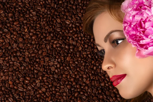 profile face with peony on coffee beans