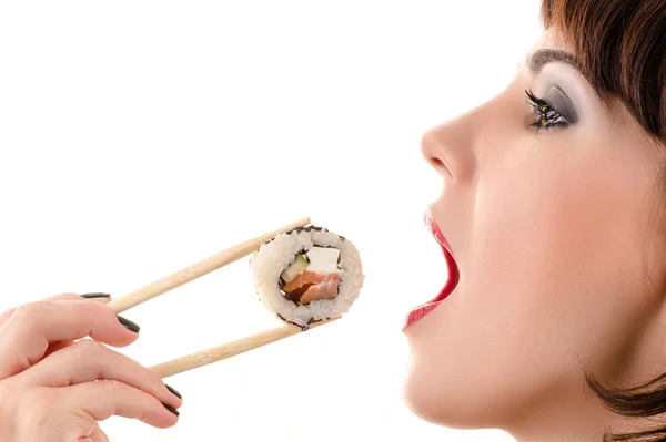 Attractive woman eating with chopsticks roll — Stock Photo, Image