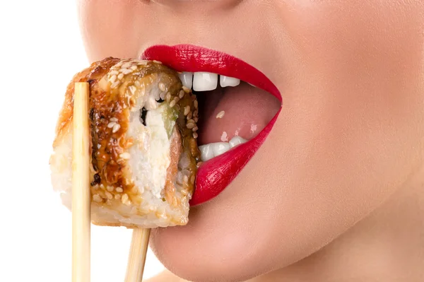 Sexy woman eating roll with sesame — Stock Photo, Image