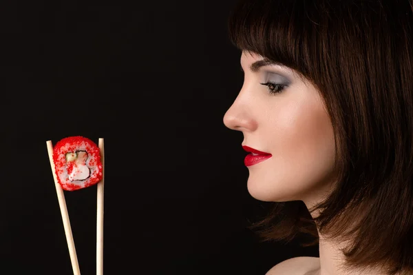 Beautiful profile face woman with chopsticks and roll — Stock Photo, Image