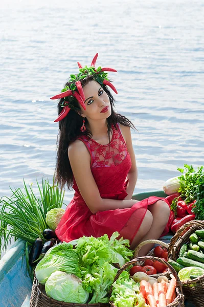 Girl in the boat with vegetables — Stock Photo, Image