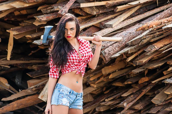 Sexy woman in plaid shirt with ax — Stock Photo, Image