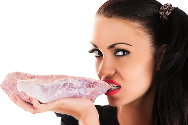 Beauty hungry woman eating raw meat in hand — Stock Photo, Image