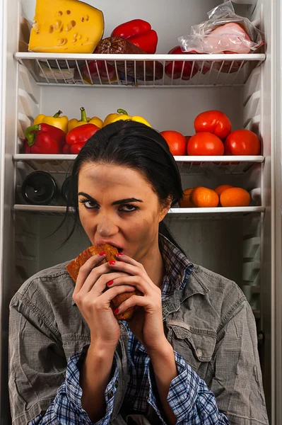 Hungry dirty woman eats meat — Stock Photo, Image