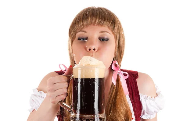 Oktoberfest waitress blows with beer foam isolated on white — Stock Photo, Image