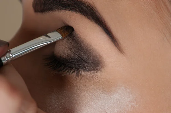 Artista de maquillaje trabajando con el cepillo de maquillaje de ojos — Foto de Stock