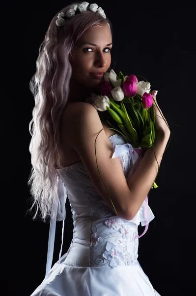 Charming woman with a bouquet of tulips