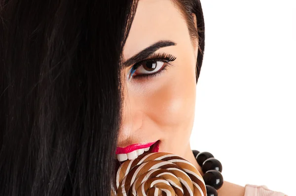 Beautiful woman face with a lollipop — Stock Photo, Image