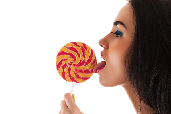 Attractive woman licking a lollipop — Stock Photo, Image