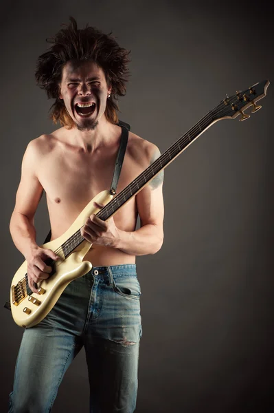 Brutal man musician playing guitar — Stock Photo, Image