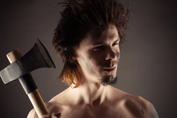 Portrait of unshaven man with an ax in hand — Stock Photo, Image