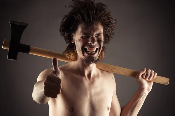 Laughing man with an ax in hand — Stock Photo, Image