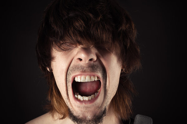 Portrait of a handsome man screaming