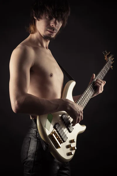 Young man playing bass guitar — Stock Photo, Image