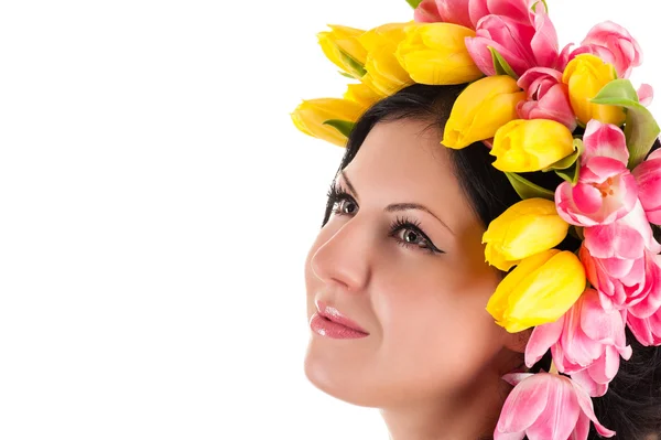 Beautiful woman with tulips on the head looking up — Stock Photo, Image