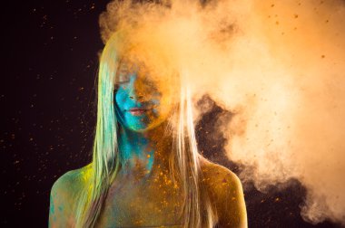 attractive girl in blue and orange colors Holi