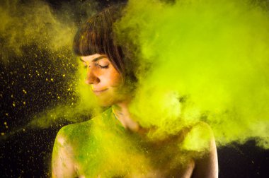 beautiful brunette in a green paint Holi